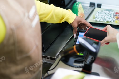 Preview: Woman's hands charging a client who pays with her mobile