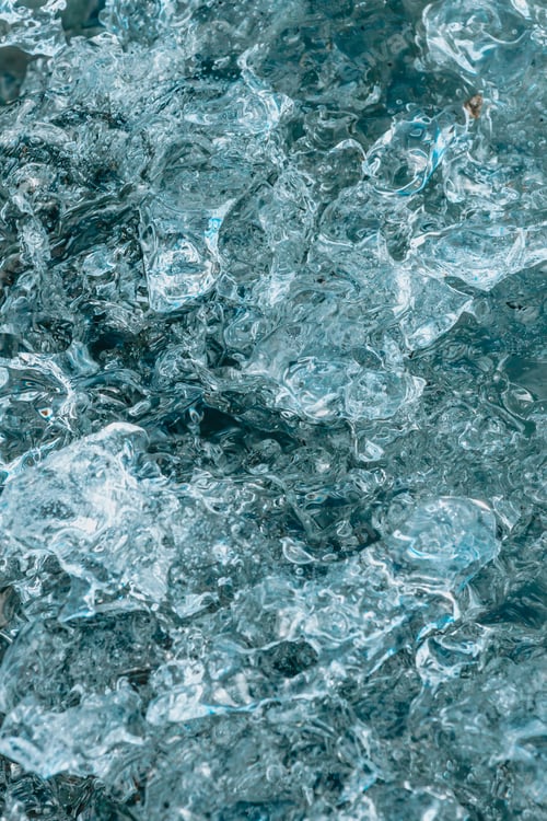 Preview: Iceland blue ice abstract background with volcanic black. Blue background with cracks on the ice sur