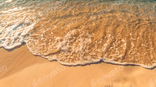 Preview: Sand on the beach and sea waves in the morning, orange tone.