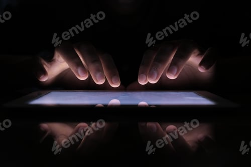 Preview: Close up of hacker hand stealing data from digital tablet