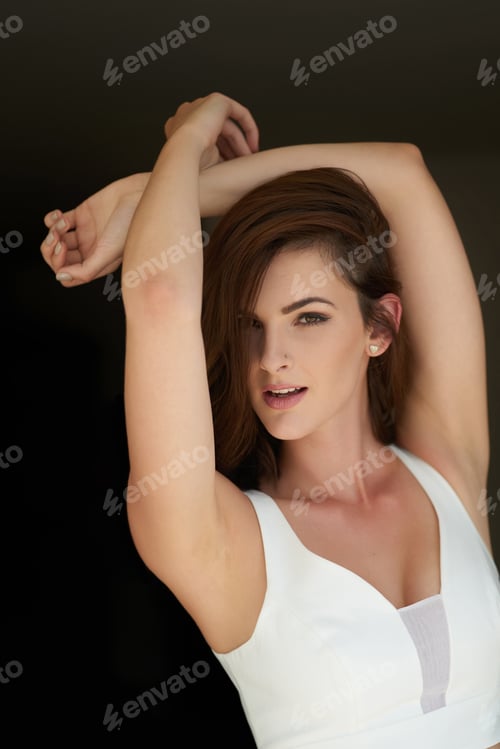 Preview: Studio portrait of an attractive young woman posing against a black background
