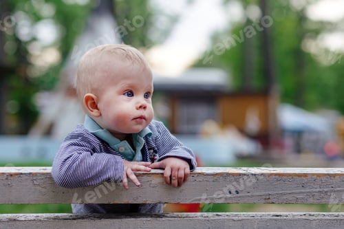 Preview: A cute little baby is looking sideways
