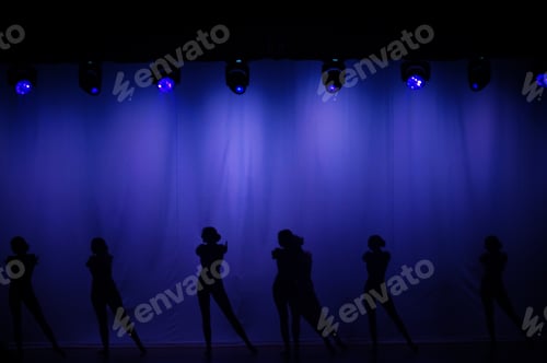 Preview: Silhouette of dancers against a beautiful blue curtain