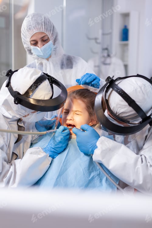 Preview: Little girl in the course of painfull caries treatment
