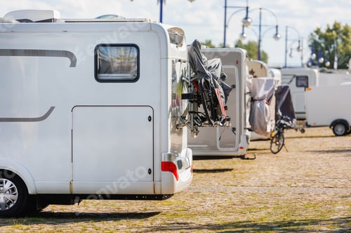Preview: Many white modern campervan recreational motor home vehicles parked in row at camper park site