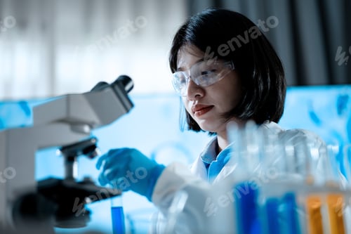 Preview: A woman in a lab coat is wearing safety goggles