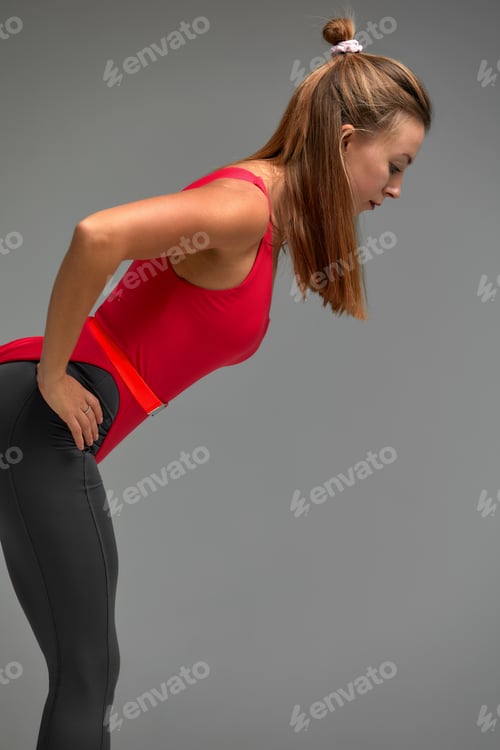 Preview: Slim fit caucasian woman practice yoga balance in fitness studio indoor on gray background