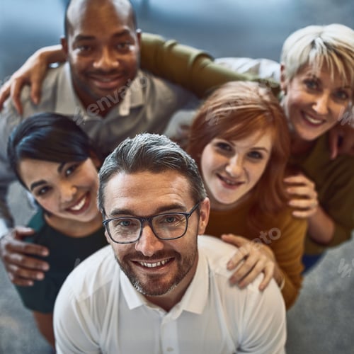 Preview: High angle portrait of a team of colleagues standing together in a modern office