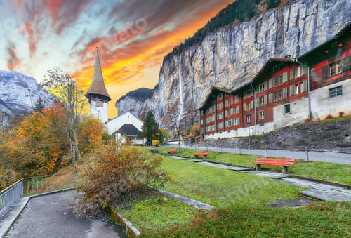 Preview: Dramatic autumn view of Lauterbrunnen village and Swiss Alps in the background
