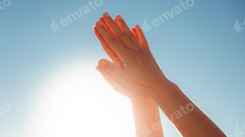 Preview: Hands raised to the sky in prayer position
