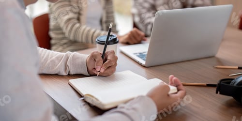 Preview: Focused Student Studying Together with Laptops and Notebooks in a Modern Classroom Setting