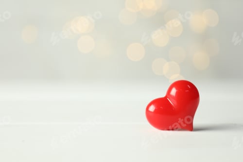 Preview: Valentine's Day. Decorative heart on white wooden background, closeup. Bokeh effect