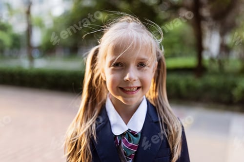 Preview: Schoolgirl back to school after vacations. Closeup portrait of Pupil in uniform early morning