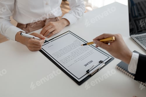 Preview: Woman candidate interview with HR manager in office, Examiner reading a resume during job interview