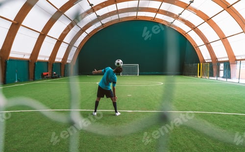Preview: Cinematic image of a soccer freestyle player making tricks with the ball.