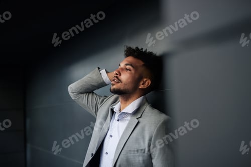 Preview: Portrait of young man student standing outdoors in city against black background