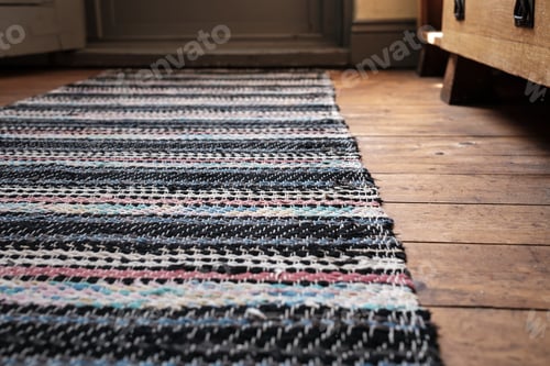 Preview: Multicolored carpet on a wooden floor near door