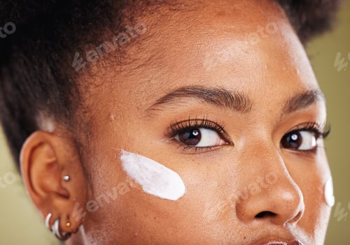 Preview: Black woman, eyes and cream for skincare cosmetics, makeup or lotion against a studio background. C