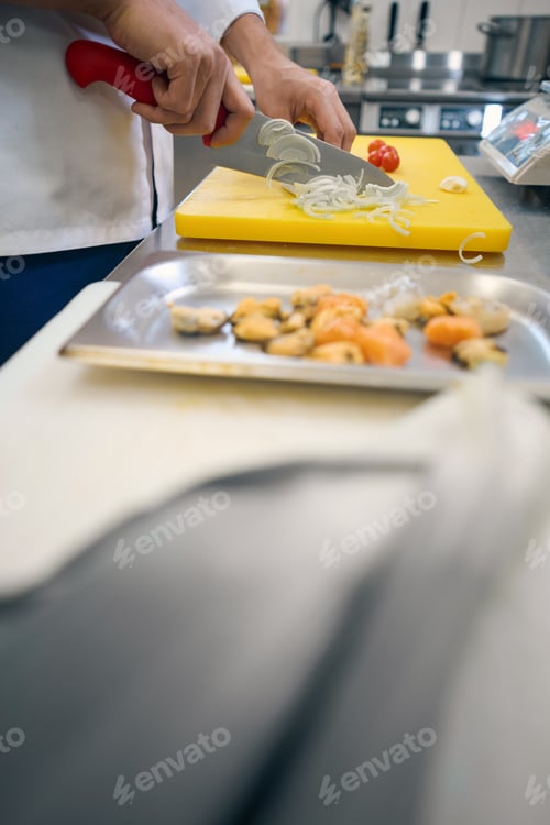 Preview: Man cuts vegetables on a yellow cutting board