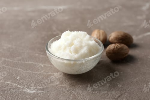 Preview: Shea butter in bowl and nuts on grey background