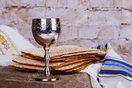 Preview: Jewish holidays: Passover Pesach matzah and a silver cup full of wine with a traditional blessing