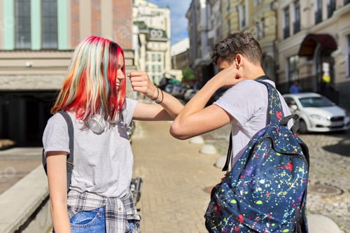 Preview: Teenagers students friends greet their elbows in the street