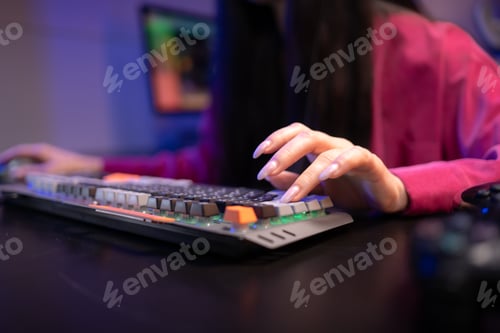 Preview: Close-up of finger typing on a mechanical gaming keyboard in a colorful LED-lit setup