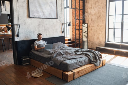 Preview: Man Relaxing in Bed Wide Angle