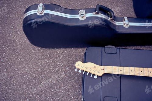 Preview: close up view of musical instruments in cases lying on street