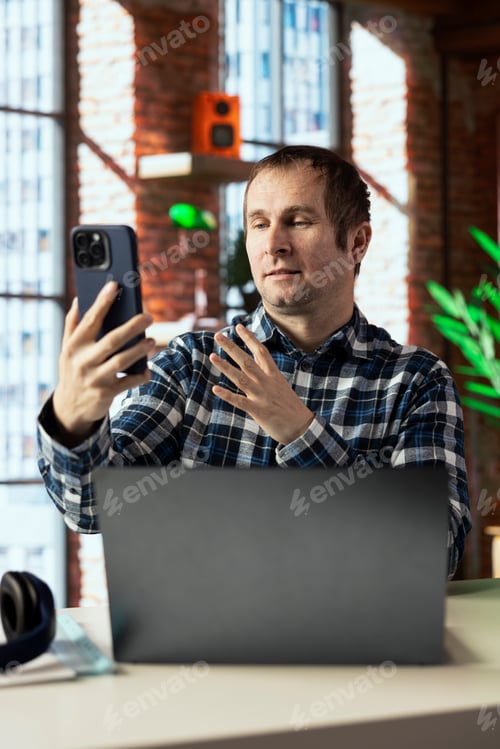 Preview: Manager calls employee remotely using internet videocall on smartphone
