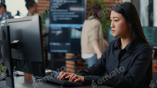 Preview: Programer writing algorithm focused on compiling source code sitting at desk
