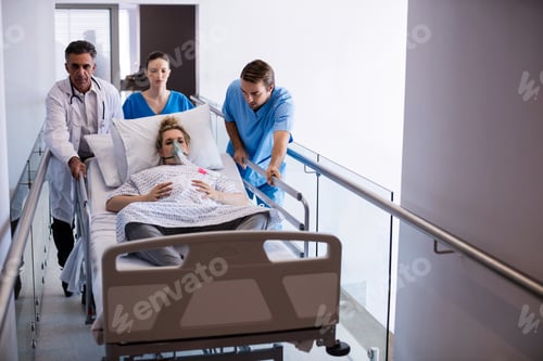 Preview: Team of doctors taking pregnant woman to operation theatre