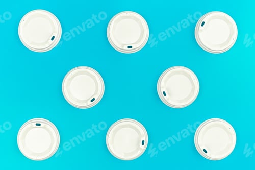 Preview: Plastic lids for disposable cups on a blue background, flat lay.