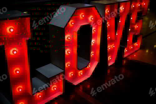 Preview: Love Sign with Red Lights on Wooden Surface