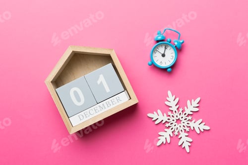 Preview: Christmas wood calendar with new year decorations, aganist colored background.