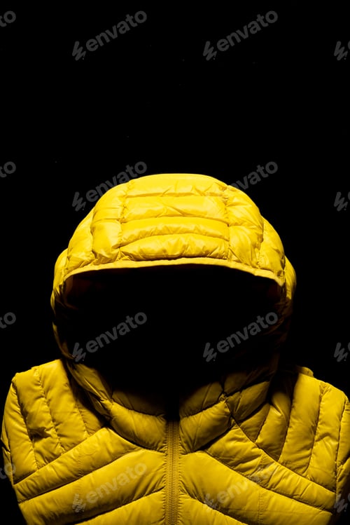 Preview: Vertical shot of a yellow down jacket on black background