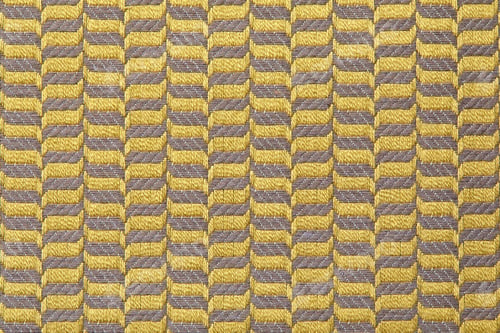 Preview: fabric in golden color with geometric patterns. mustard knitted texture, background knitted mustard