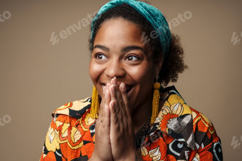 Preview: Young black woman in headband smiling and covering her mouth