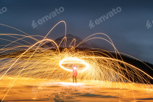 Preview: Fire show with lot of sparks in night winter mountains