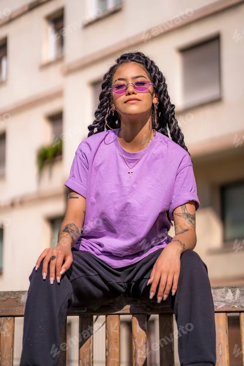 Preview: Urban session. young dark-skinned woman with long braids in purple glasses