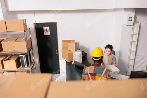 Preview: Storehouse manager gives white carboard box to employee