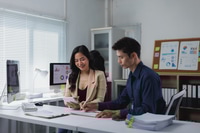 Preview: Business team analyzing financial data in office