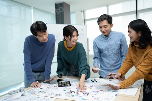 Preview: Asian team ux developer and ui designer brainstorming about mobile app interface wireframe design