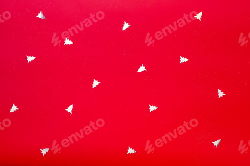 Preview: A vibrant red background featuring white Christmas trees adorning its surface