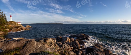 Preview: Panoramic view of a rocky ocean coast during a vibrant sunny sunset