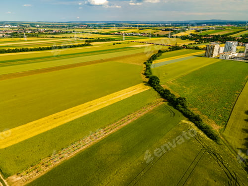 Preview: Drone view of vineyards wheat rape seed fields in southern Vienna with apartment buildings