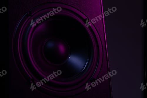 Preview: large speaker close-up on a black background with violet-purple illumination close-up, music