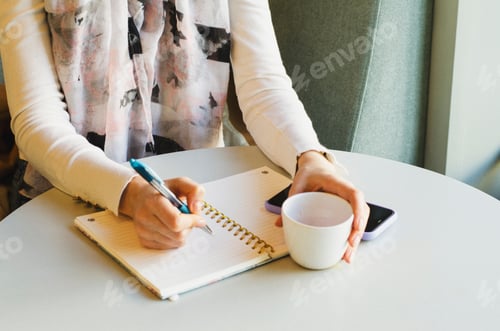 Preview: Girl writes in a notebook. Business woman