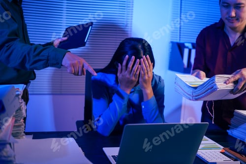 Preview: Two men bring a large workload to a woman at her desk in the office. She feels stressed pressured