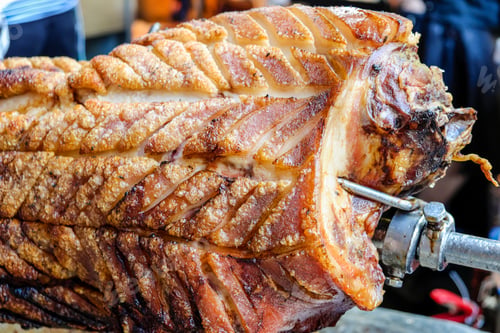 Preview: Closeup of roast pork on a spit